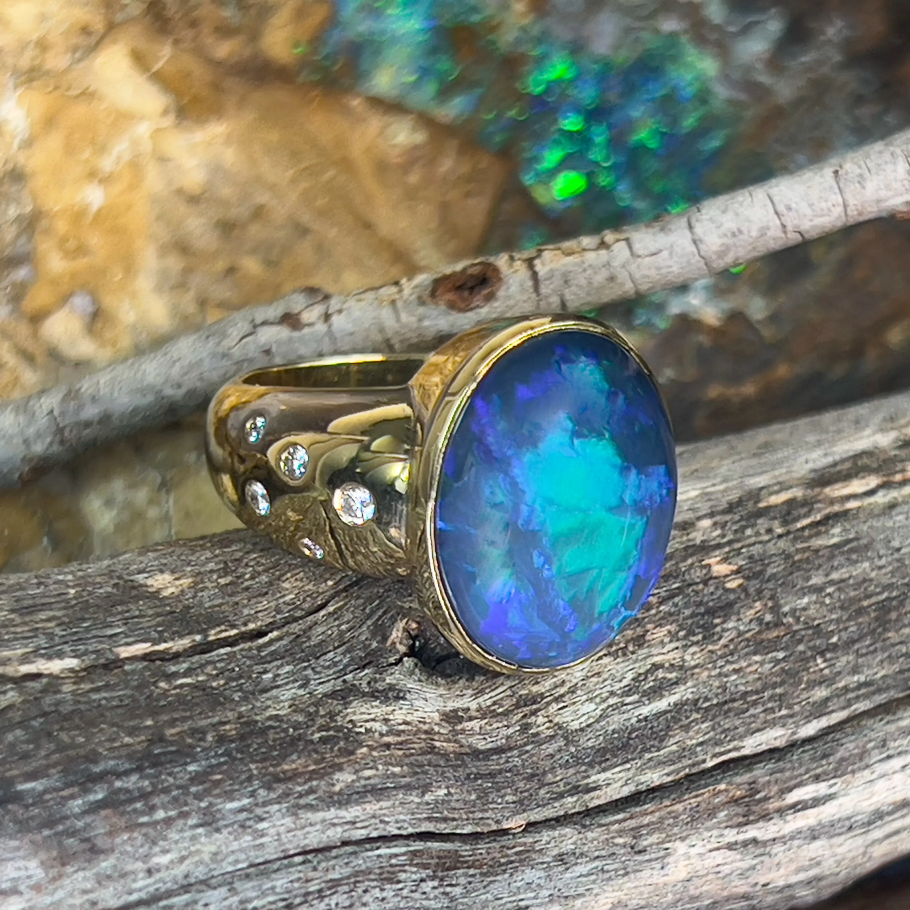 18kt Yellow Gold bezel set band Black Opal 6.05ct and diamonds flush set ring